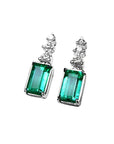 Emerald earrings with rectangular medium bluish-green emeralds and accent diamonds in 14K white gold.