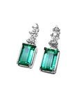 Emerald earrings with rectangular medium bluish-green emeralds and accent diamonds in 14K white gold.