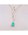 14K yellow gold twisted slider necklace with a pear-shaped emerald and diamond accents.
