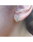 Women's 14K yellow gold braided geometric stud earring with a deep green emerald and clear stone.