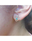 Women's 14K yellow gold braided geometric stud earring with a deep green emerald and clear stone.