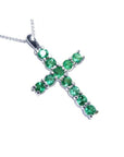 18K white gold cross pendant with eleven round-cut natural Colombian emeralds.