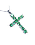 18K white gold cross pendant with eleven round-cut natural Colombian emeralds.