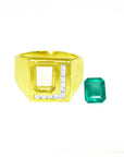 Men's 18K yellow gold ring with channel-set diamonds and a loose rectangular Colombian emerald.