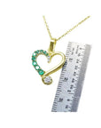18K yellow gold heart pendant with natural emeralds and diamonds, shown with a ruler for size.