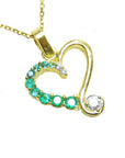 Gold heart-shaped pendant with round cut emeralds gemstones on a white background.