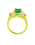 1.27 ct natural Colombian emerald three-stone ring in 18K yellow gold with trillion diamonds.