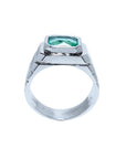 Men's 18K white gold ring with a bezel-set, modified emerald-cut deep bluish-green Muzo Colombian emerald.