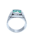 Men's 18K white gold ring with a bezel-set, modified emerald-cut deep bluish-green Muzo Colombian emerald.