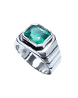 18K white gold men's ring with a bezel-set, modified emerald-cut deep bluish-green emerald.