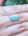 Halo diamond Emerald necklace elongated natural Colombian emerald 3.48 carats east west orientation in 18k white gold