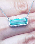 Muzo Colombia Emerald necklace 3.48 carats east west orientation encircle by halo diamonds crafted in 18k white gold