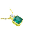 18K yellow gold necklace with a large asscher cut Colombian emerald and a princess cut diamond.