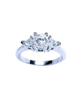 14K white gold engagement ring with a round center diamond and two trillion side diamonds.