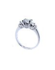 14K white gold three-stone engagement ring with round cut diamonds and pave set accents.