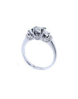 14K white gold three-stone engagement ring with round cut diamonds and pave set accents.