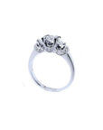 14K white gold three-stone engagement ring with round cut diamonds and pave set accents.