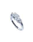 14K white gold three-stone round cut diamond engagement ring with pave set accent diamonds.
