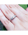 Round cut three stone diamond engagement ring in 14K white gold with pave set accent diamonds.