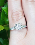 Round cut diamond three stone ring side tapper baguette