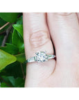 Round cut diamond three stone ring side tapper baguette