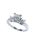 White gold 14K three-stone princess cut diamond ring with a large center stone.