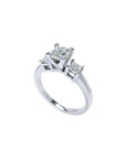 White gold 14K three-stone ring with a large princess cut diamond flanked by two smaller princess cut diamonds.