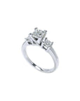 White gold 14K three-stone ring with a large princess cut diamond flanked by two smaller princess cut diamonds.