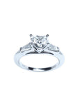 14K white gold ring with a heart-cut diamond center stone and two side baguette diamonds.