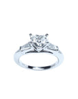 14K white gold ring with a heart-cut diamond center stone and two side baguette diamonds.