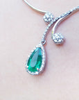 Women's natural emerald necklace: this is a natural emerald, encircled in a halo of natural diamond set in 18k white gold