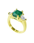 18K yellow gold ring with a GIA certified emerald and side trillion diamonds.
