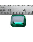 GIA certified 3.55 ct. emerald-cut Colombian emerald gemstone, measured against a ruler.