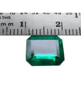 GIA certified 3.55 ct. emerald-cut Colombian emerald gemstone, measured against a ruler.
