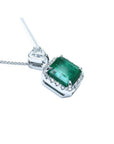A GIA certified F1 colombian emerald pendant, crafted in 18k white gold.