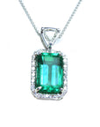 The topside of this certified natural emerald pendant shows the top bail slider with a trillion-cut diamond and the emerald with a halo diamond.