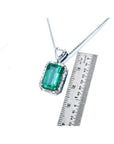GIA certified 5.65 ct medium-deep green Colombian emerald pendant with diamond halo in 18K white gold.