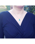 GIA certified 5.65 ct. medium-deep green Colombian emerald halo diamond pendant on 18K white gold chain.