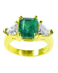 A natural Muzo colombian emerald ring GIA certified with side trillion cut diamonds made of 18k yellow gold.