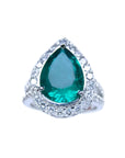 A GIA certified pear shaped natural colombian emerald ring for women with a halo of genuine diamonds in 18k white gold.