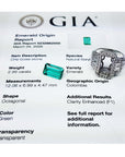 GIA emerald origin report with a loose emerald stone and ring on a white background.