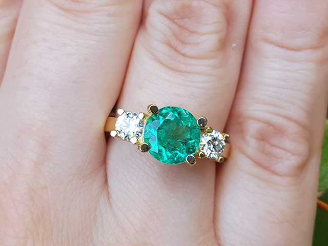 Round emerald and diamond ring