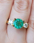 Round emerald and diamond ring