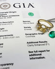 GIA certified 2.44 ct. round Colombian emerald, 18K yellow gold three-stone ring setting with accent diamonds.