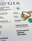 GIA certified 2.44 ct. round Colombian emerald, 18K yellow gold three-stone ring setting with accent diamonds.
