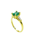 14K yellow gold ring with a rectangular emerald and baguette side diamonds.