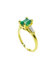 14K yellow gold ring with a rectangular emerald and baguette side diamonds.