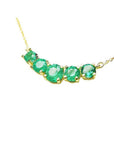 14K gold necklace with five round, medium green Colombian emeralds in basket settings.