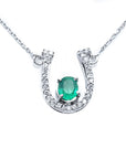 Horseshoe emerald and diamond necklace