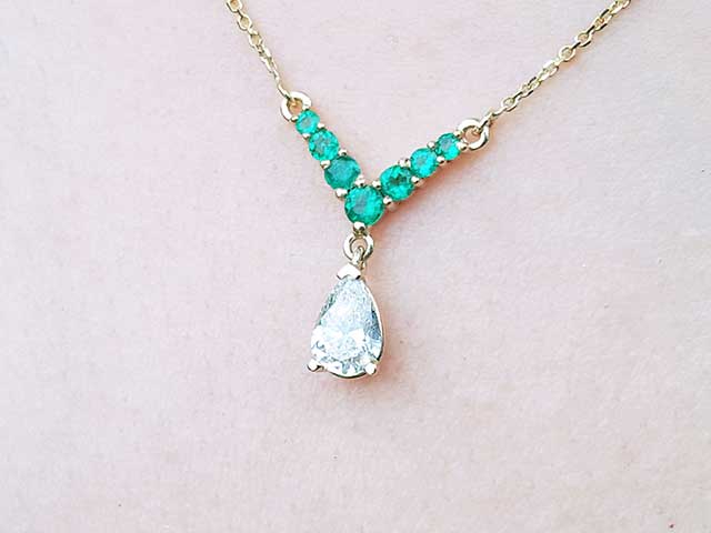 Pear cut diamond and emerald necklace